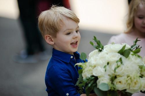 young boy holding flowers l children's dentist near me