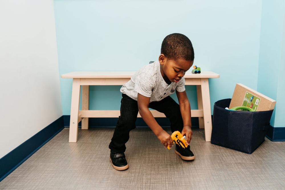 young boy playing with toy on the floor | pediatric dentist apple valley mn