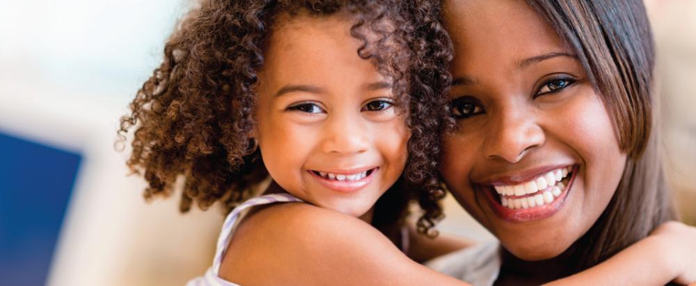 woman and daughter hugging | apple valley mn pediatric dentist