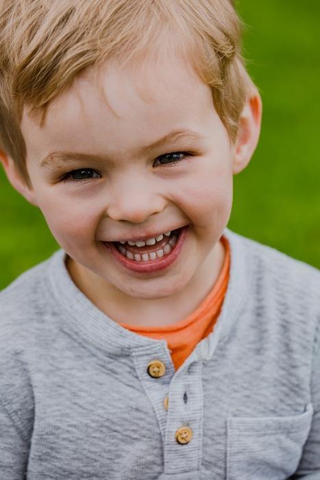 young boy smiling outside l dentist apple valley mn