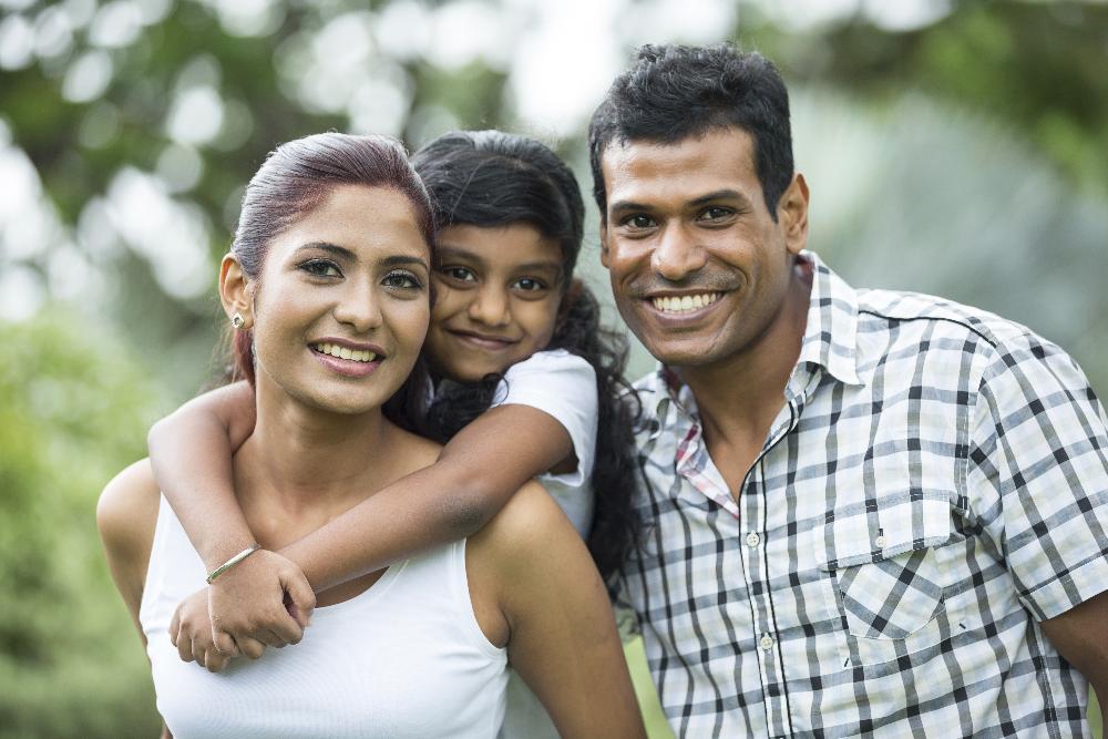 family of three hugging | interceptive orthodontics apple valley mn