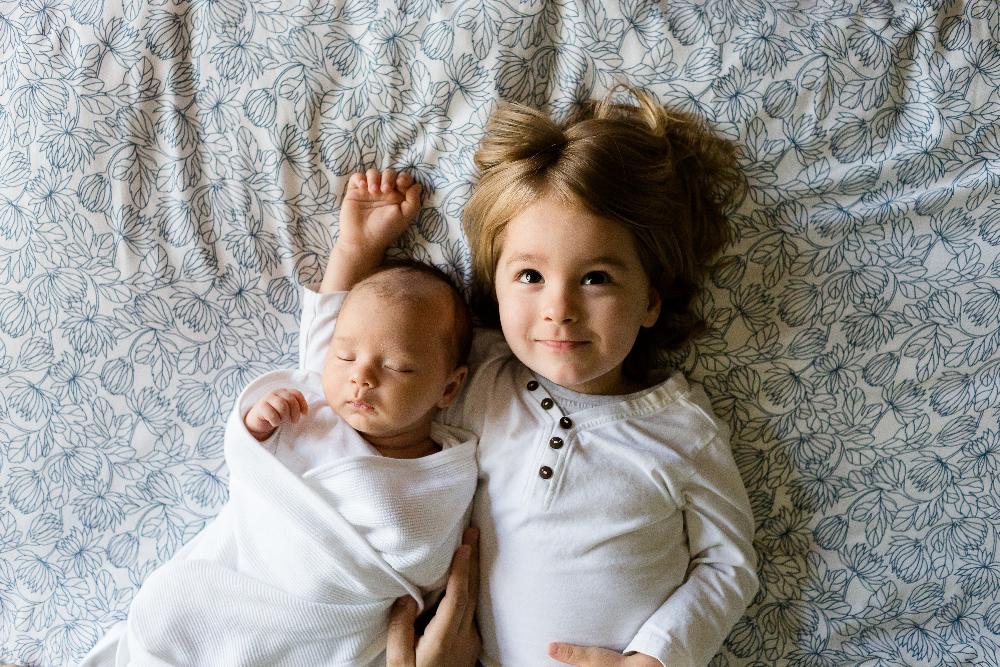 young girl with baby hugging | carousel dentist