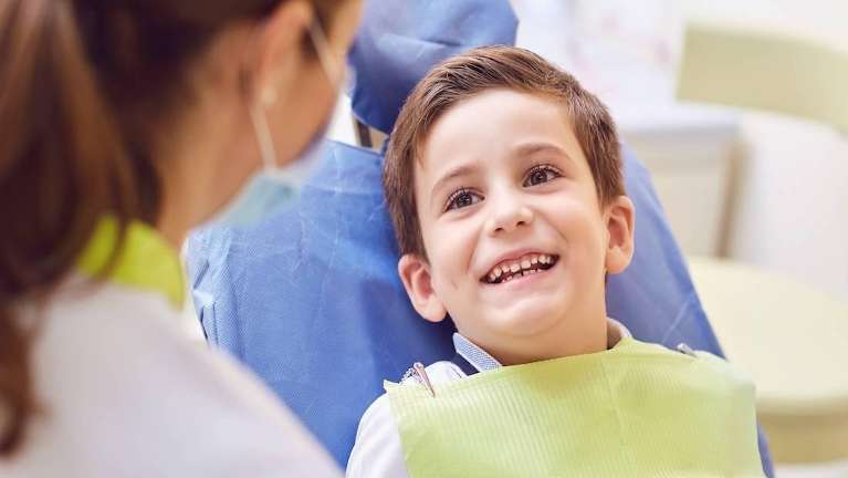 little boy smiling in dentist exam chair | emergency dentist apple valley mn