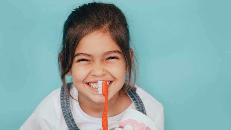 Girl Cleaning Her Teeth | pediatric dentist apple valley