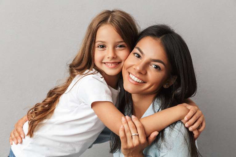 woman with daughter hugging | pediatric dentist apple valley mn