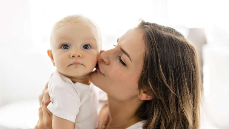 woman kissing baby | pediatric dentist apple valley