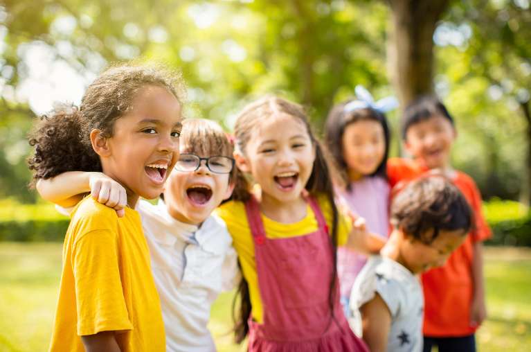 group of children hugging outside | children's dentist apple valley mn