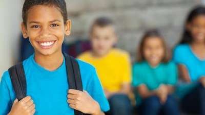 child withbackpack smiling | comprehensive pediatric dentistry & orthodontics