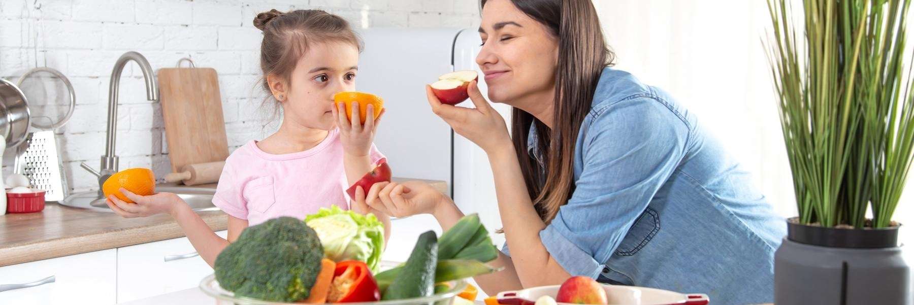 woman with child cooking in kitchen | pediatric dentistry apple valley mn