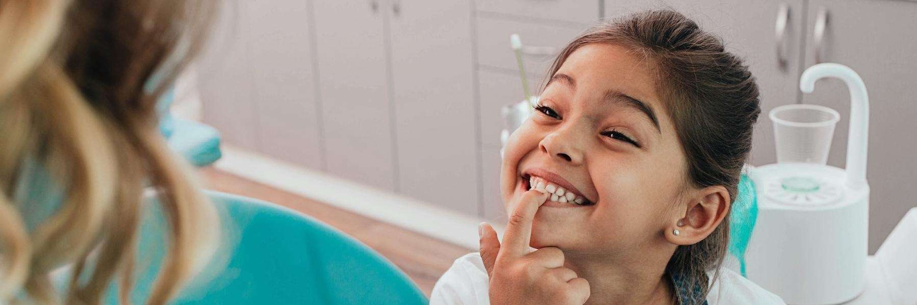 child showing off bright smile to parent | apple valley pediatric dentist