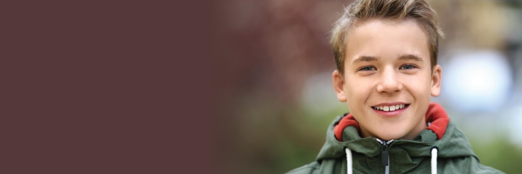 young boy with brown hair smiling l emergency dentist apple valley mn